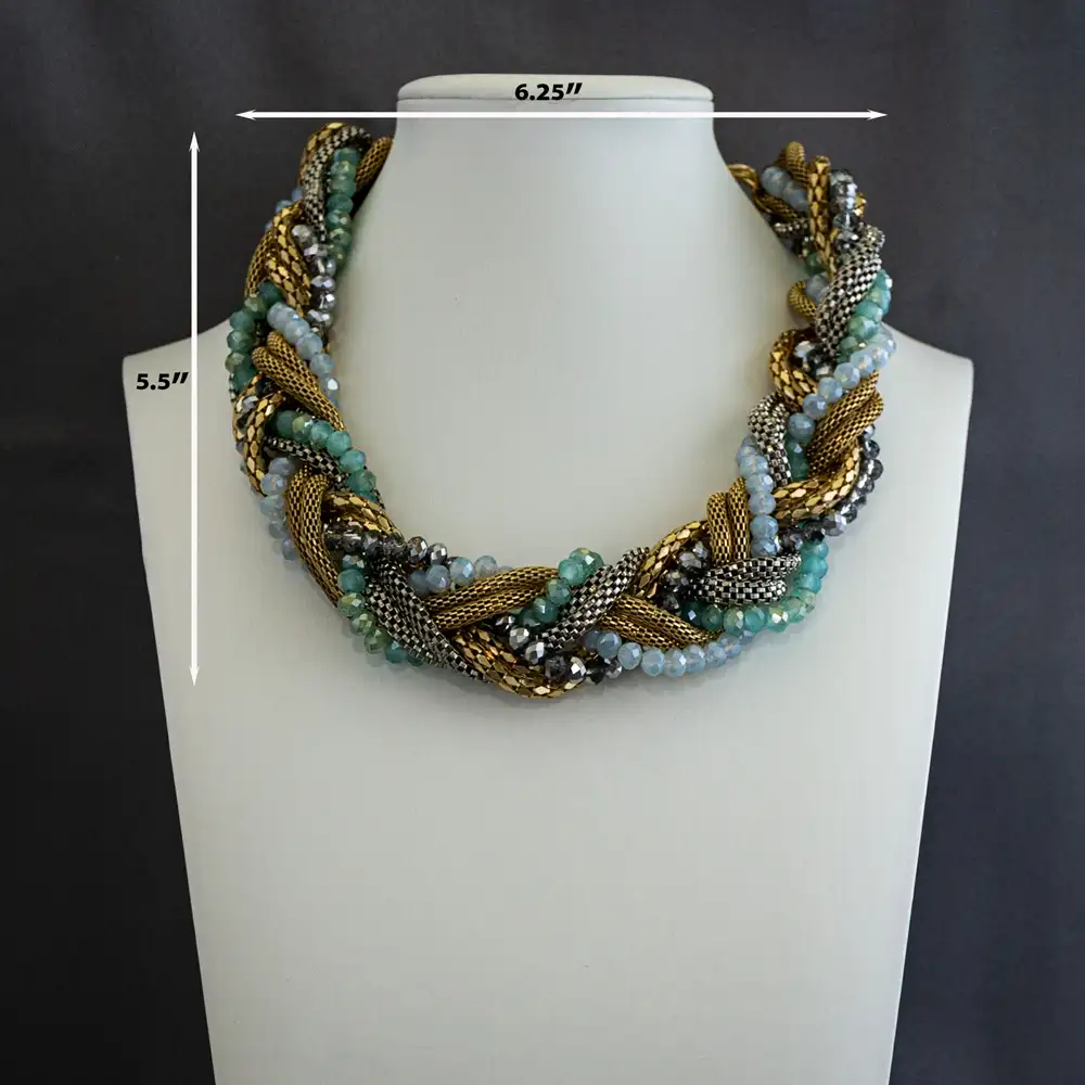 Dimensions of a statement necklace features six strands artfully intertwined into one dynamic design. Combining two polished gold-tone strands, one sleek silver strand, and three shimmering strands of faceted glass