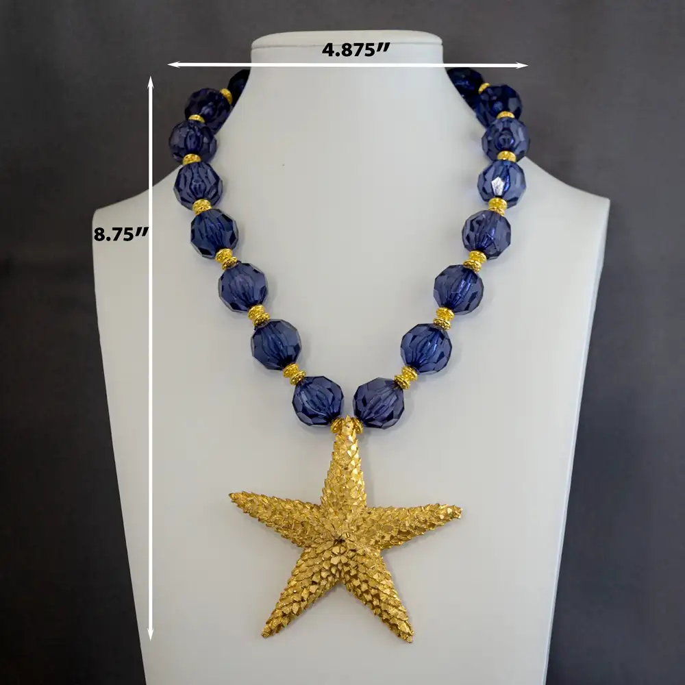 Dimensions of a bold vintage statement necklace centers on a 3.25-inch, 5-point, star shaped textured gold-tone pendant.