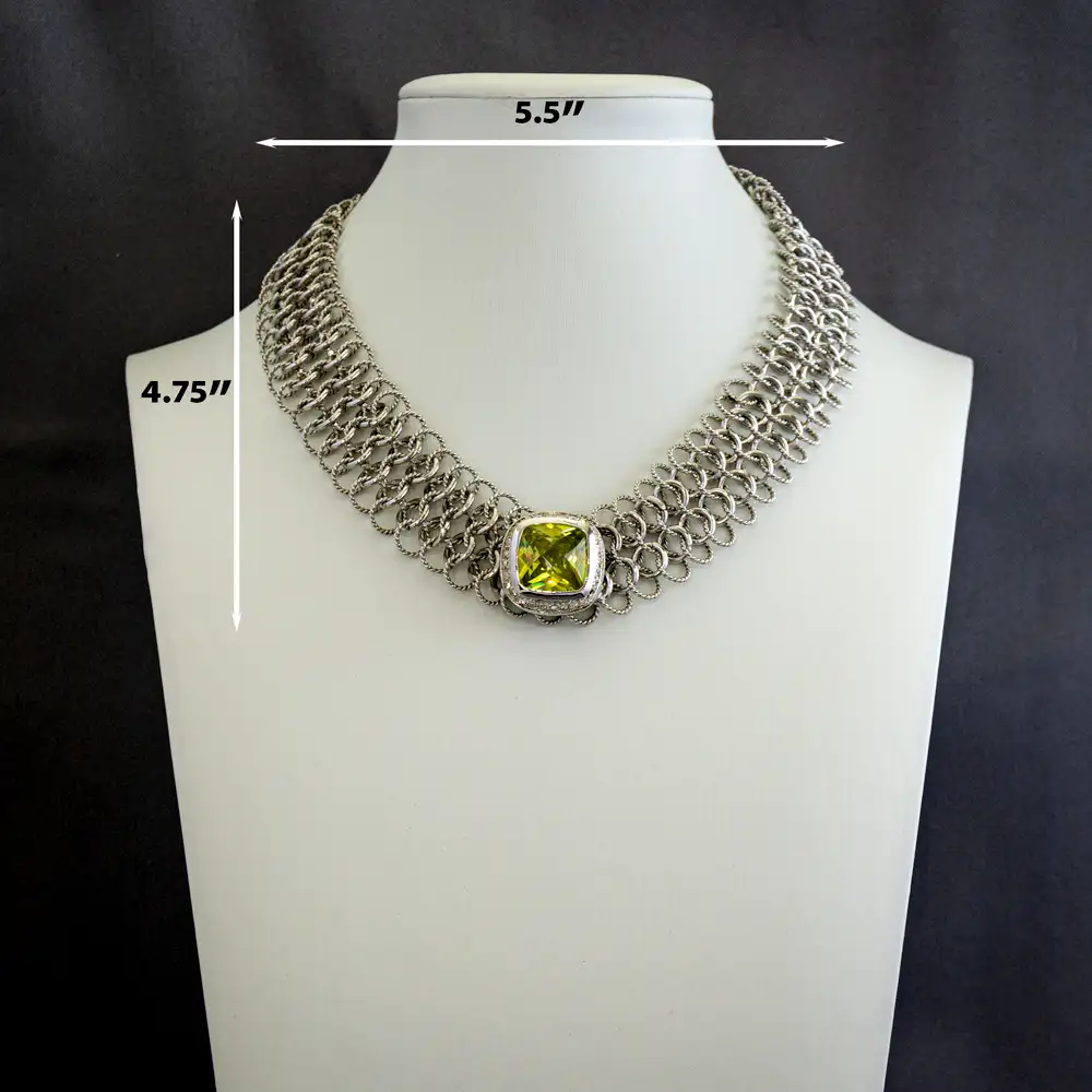 Dimensions of a Close up of a 16-inch necklace features a band of intricately intertwined smooth and textured silver-tone rings.
