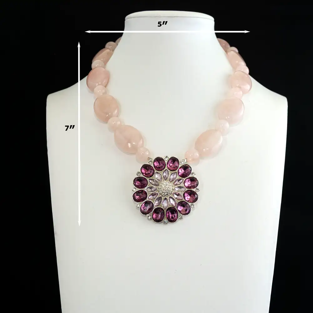 Description of statement necklace. Soft, opaque rose quartz beads rhythmically alternate in 10mm and 18mm sizes for dynamic, eye-catching dimension.