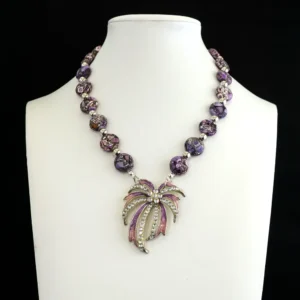 Vintage 13mm flat purple king cobra jasper stones alternate with sleek 5.5mm silver-tone spacers, creating a bold and captivating pattern.