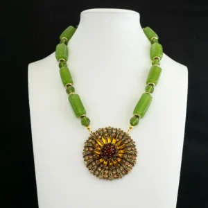 vintage necklace with a Large rectangular green glass stones pair seamlessly with 9mm faceted green glass beads, separated by warm gold-tone spacers for dynamic texture.