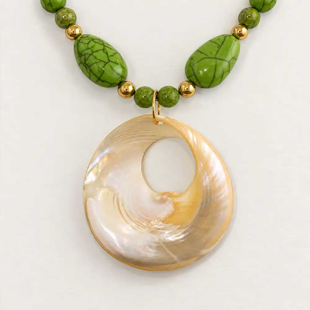 Closeup of a vintage 20-inch necklace features a bold band of large, eye-catching apple green howlite stones.