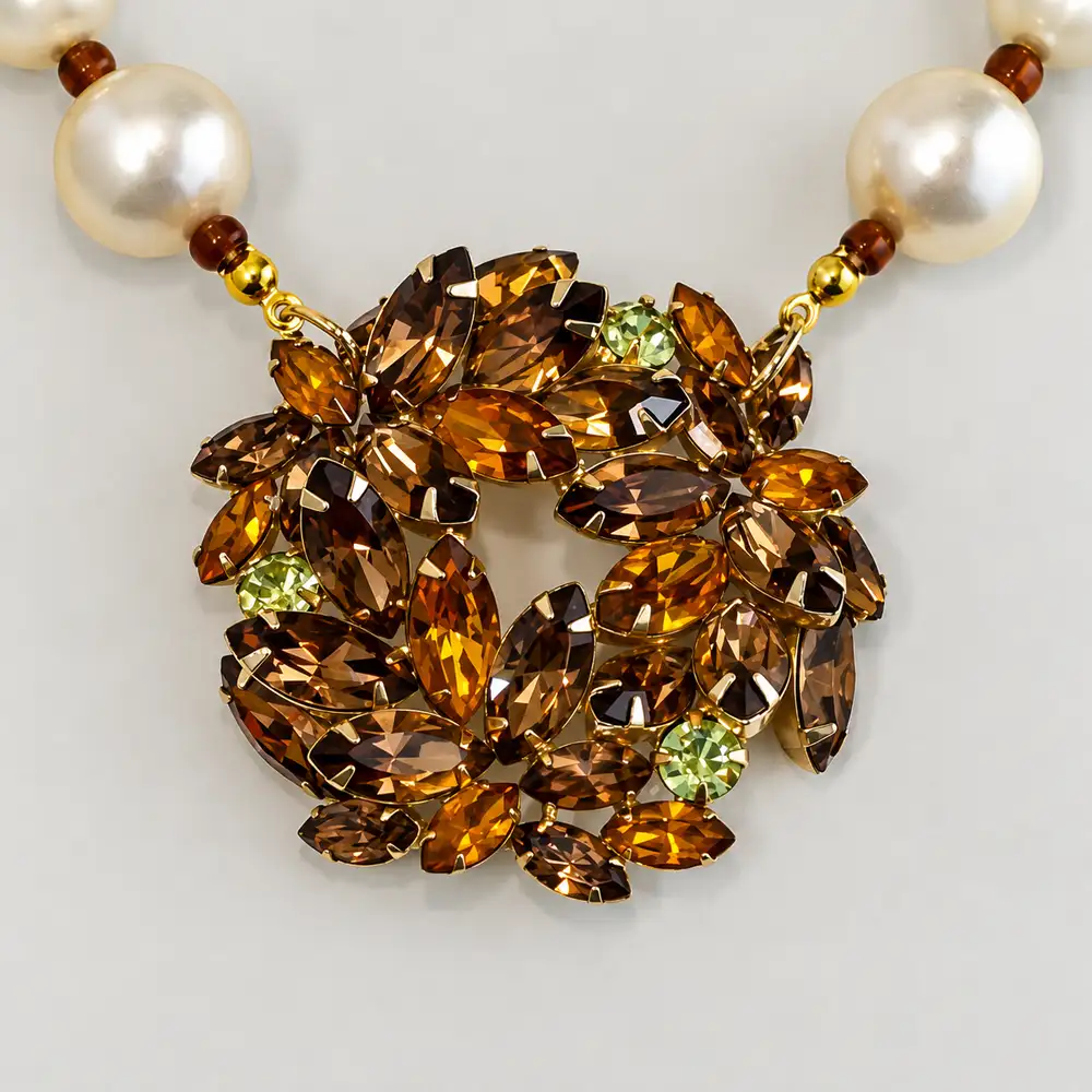 closeup of exquisite vintage necklace, 12mm glass pearls is subtly separated by delicate gold-tone spacers.