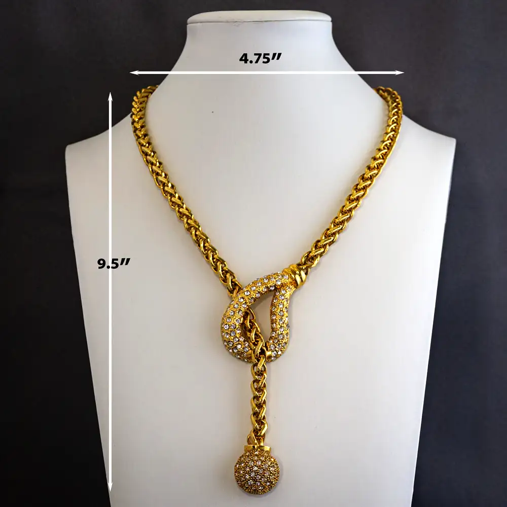 Dimensions of a 17-inch vintage Traci Lynn lariat necklace features a bright gold-tone chain complemented by a half-globe pendant with an elegant 3.5-inch drop.