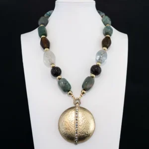 This striking statement necklace features an eclectic strand of variegated green, amber, clear, and speckled glass beads separated by gold-tone spacers.