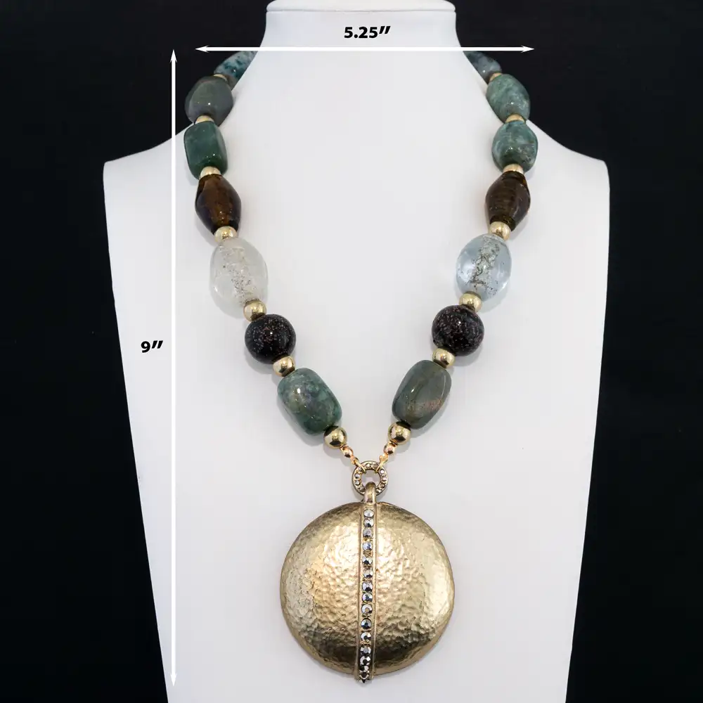 description of a striking statement necklace features an eclectic strand of variegated green, amber, clear, and speckled glass beads separated by gold-tone spacers.