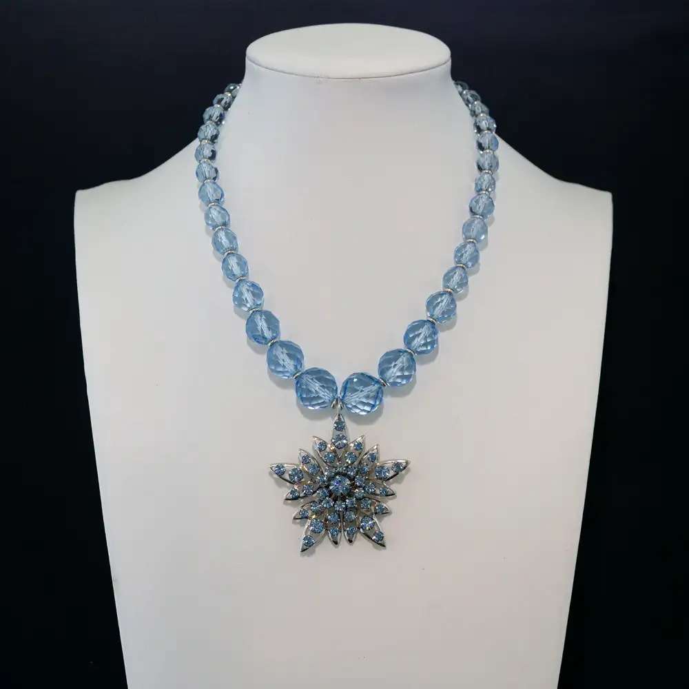 This dazzling necklace features light blue faceted glass beads that catch the light from every angle.