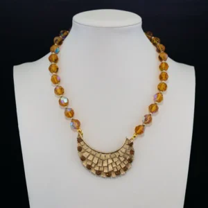 This beautiful necklace features shimmering topaz-hued, faceted glass beads with an iridescent aurora borealis finish.