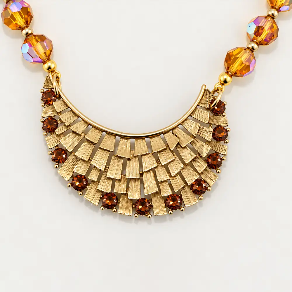 Close up of a beautiful necklace features shimmering topaz-hued, faceted glass beads with an iridescent aurora borealis finish.
