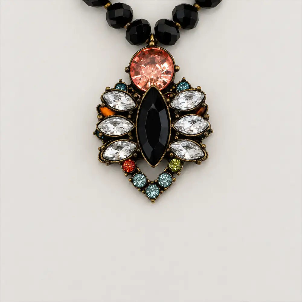 Closeup of a vibrant vintage pendant measuring 1.25 inches wide by 1.5 inches long, this 15-inch necklace sparkles with clear, pink, turquoise, and chartreuse rhinestones