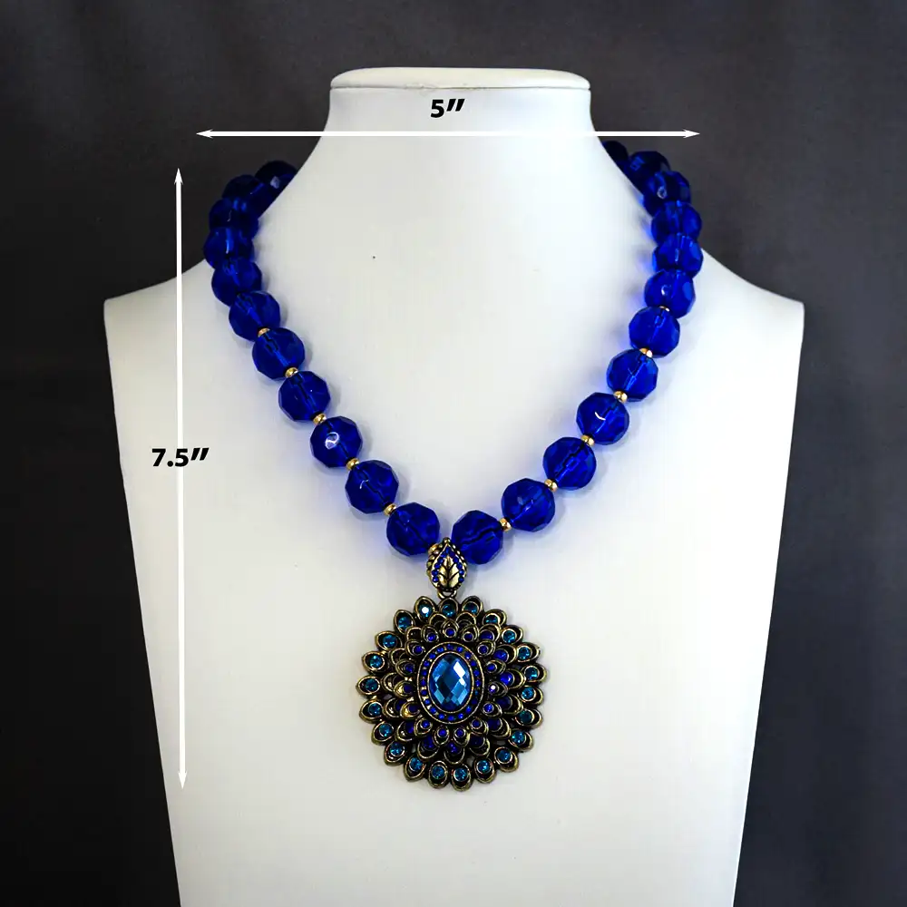 Dimensions of a 2-inch round vintage pendant, this 16-inch necklace features radiant cobalt and teal rhinestones nestled in antiqued gold settings.