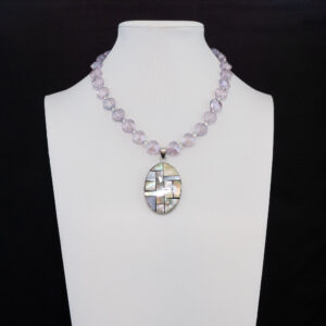 charming necklace features a strand of translucent, lavender heart-shaped glass beads that softly reflect the light.