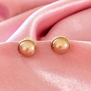 elegant clip-on earrings feature smooth, 0.75-inch diameter faux glass pearls set in a polished gold-toned bezel.