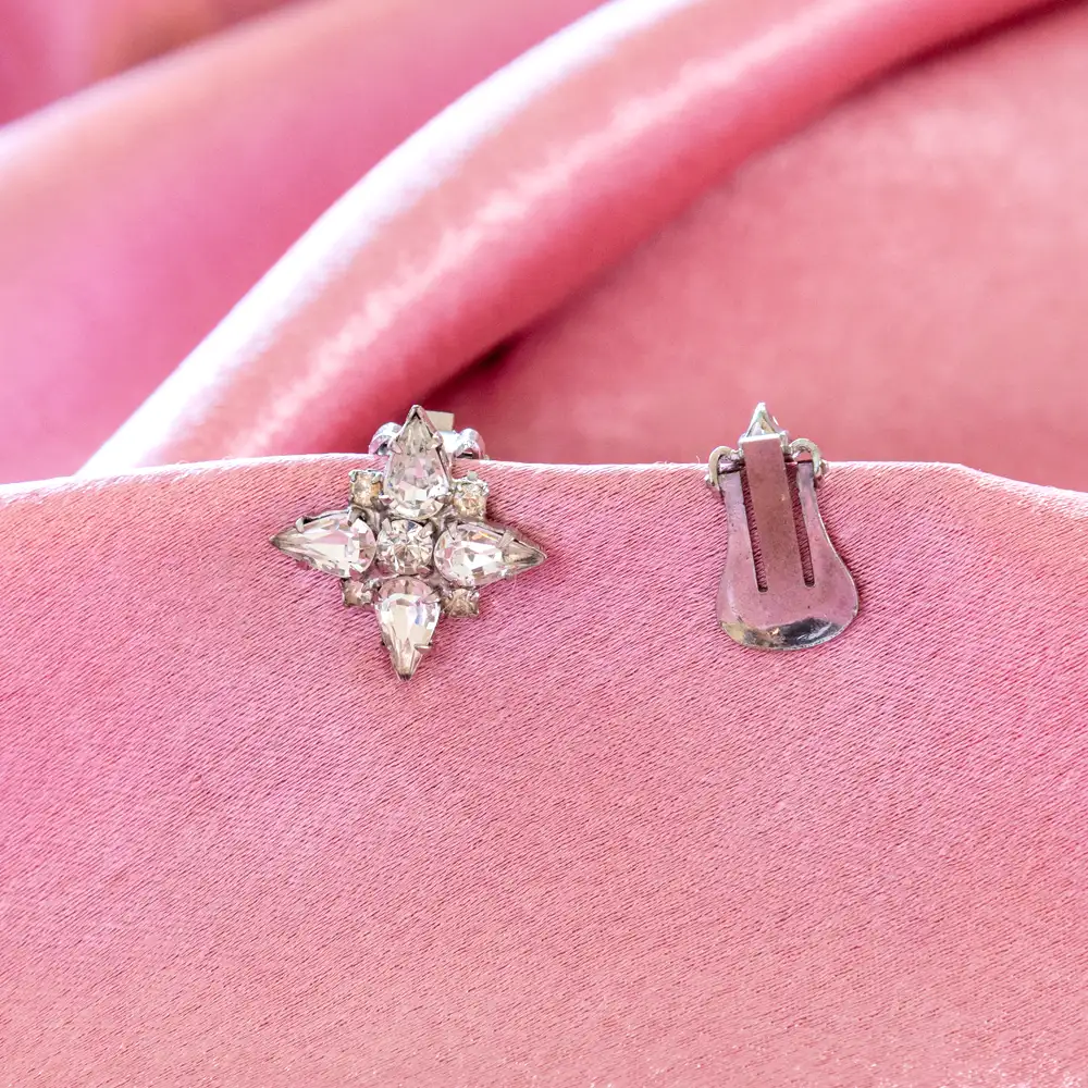 sparkling clip-on earrings showcase a brilliant cluster of teardrop and round clear rhinestones set in silver-toned metal