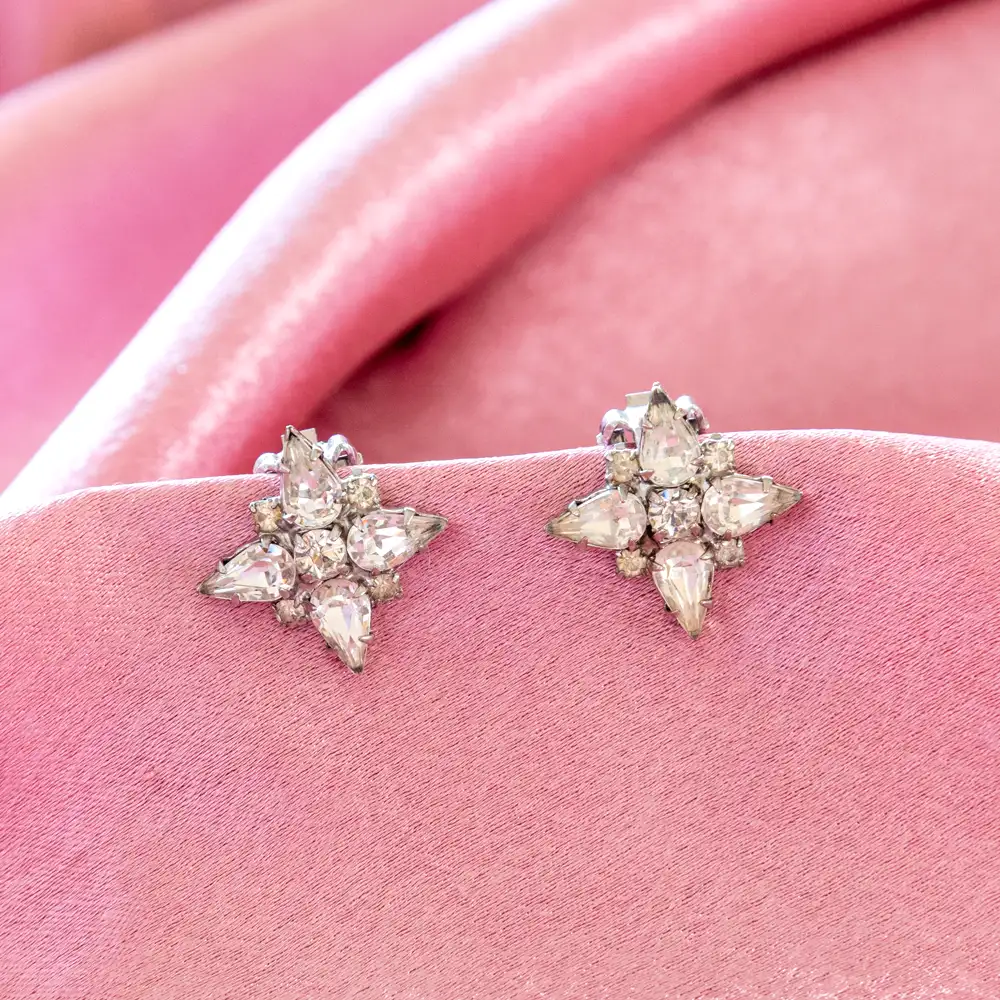 sparkling clip-on earrings showcase a brilliant cluster of teardrop and round clear rhinestones set in silver-toned metal