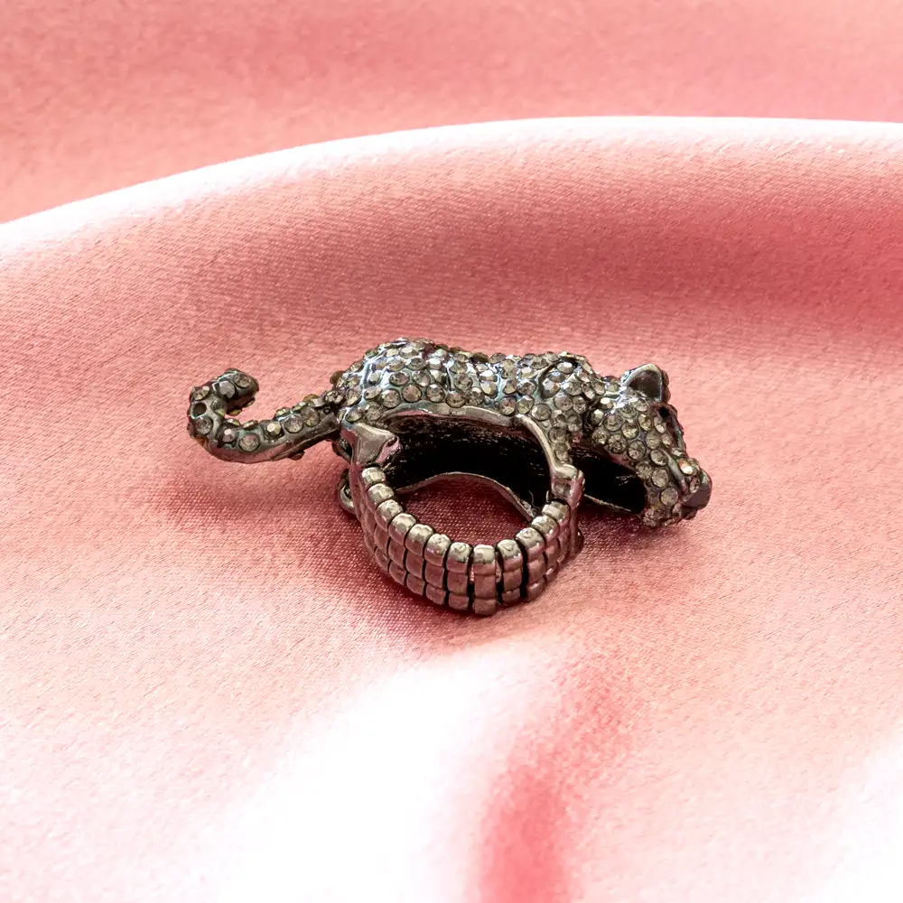 striking black panther ring features a sculpted feline silhouette atop a flexible, elasticized expansion band