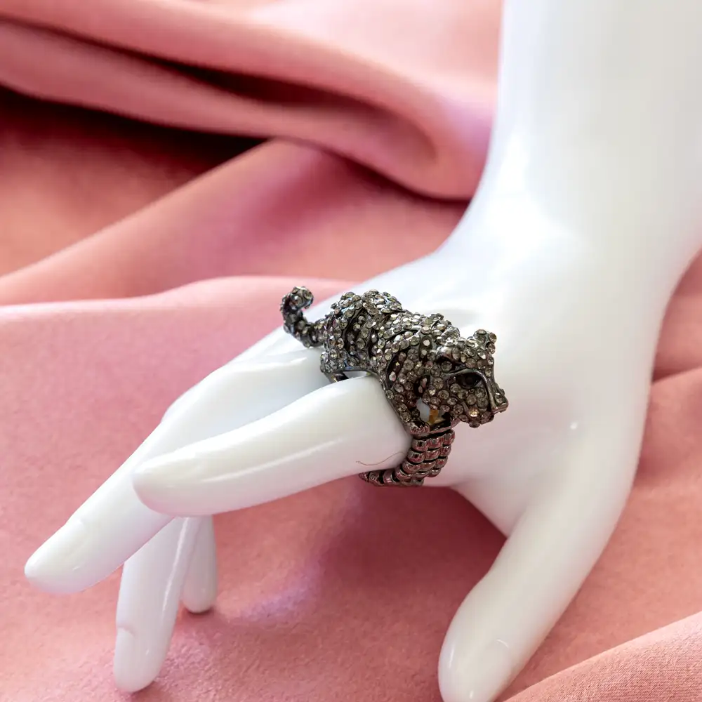 striking black panther ring features a sculpted feline silhouette atop a flexible, elasticized expansion band