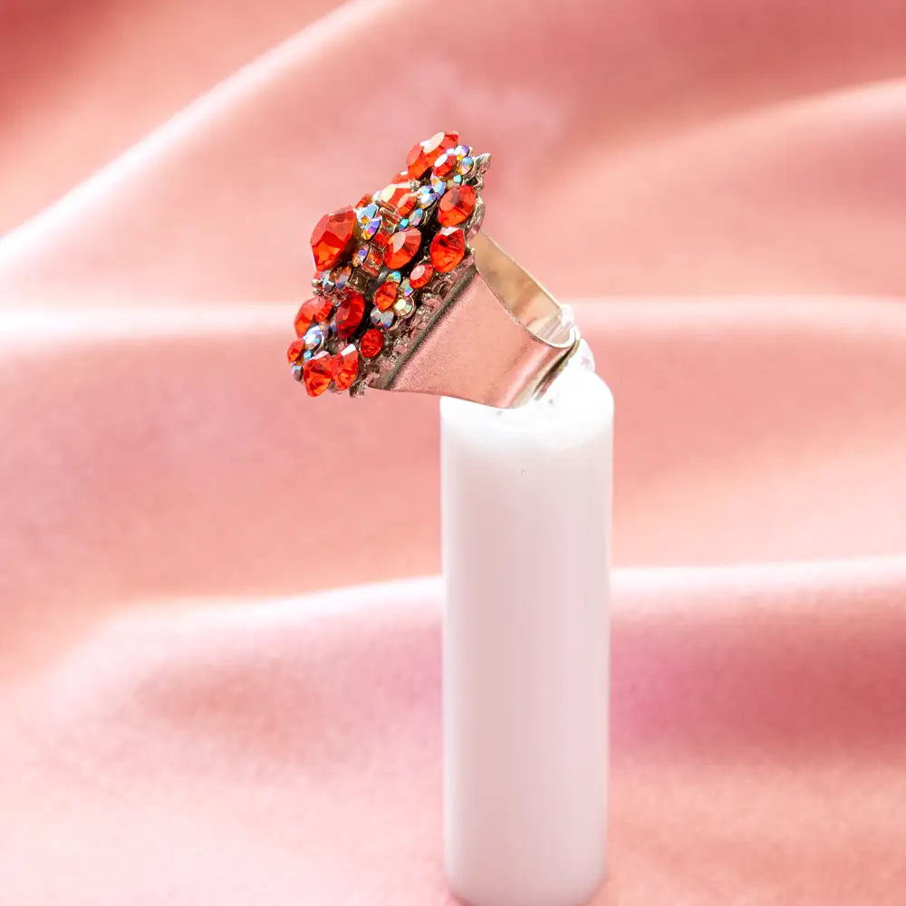 this statement cocktail ring showcases vibrant flame-orange rhinestones