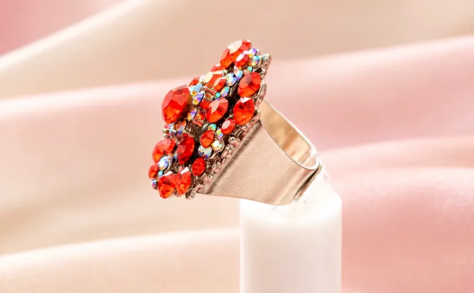 Statement cocktail ring showcases vibrant flame-orange rhinestones